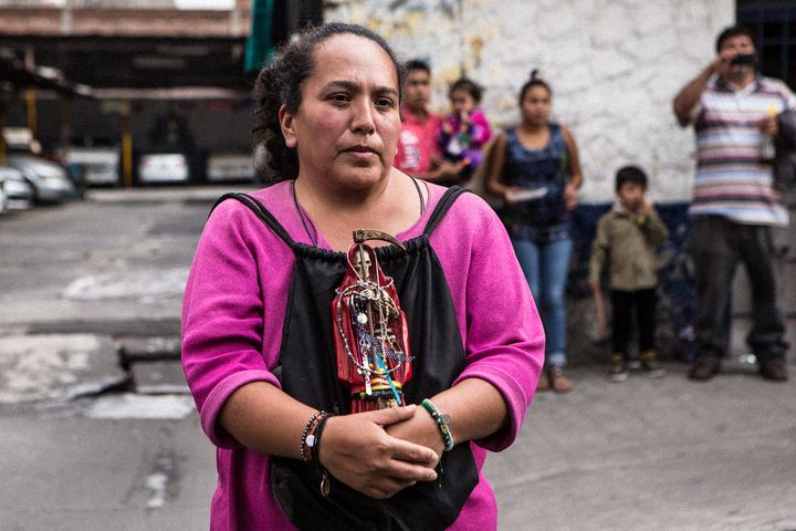 <p>Devotee who brought her Lady in Red to be blessed at the Santa Muerte shrine in Tepito</p>