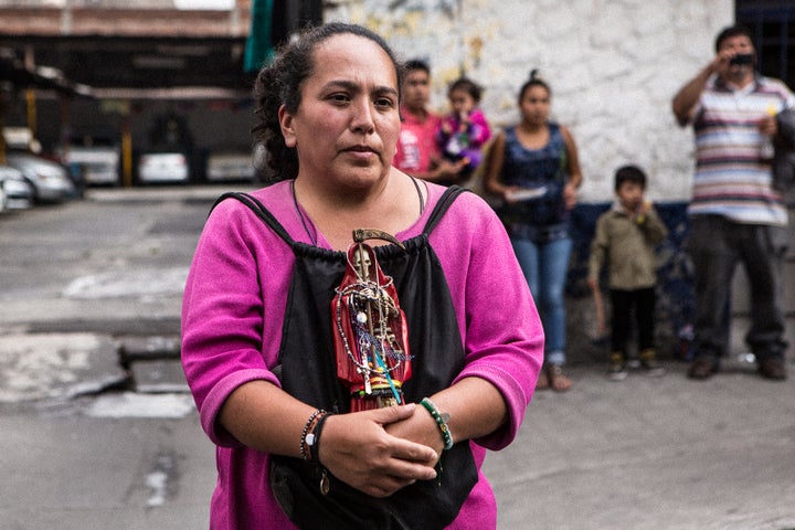 Devotee who brought her Lady in Red to be blessed at the Santa Muerte shrine in Tepito