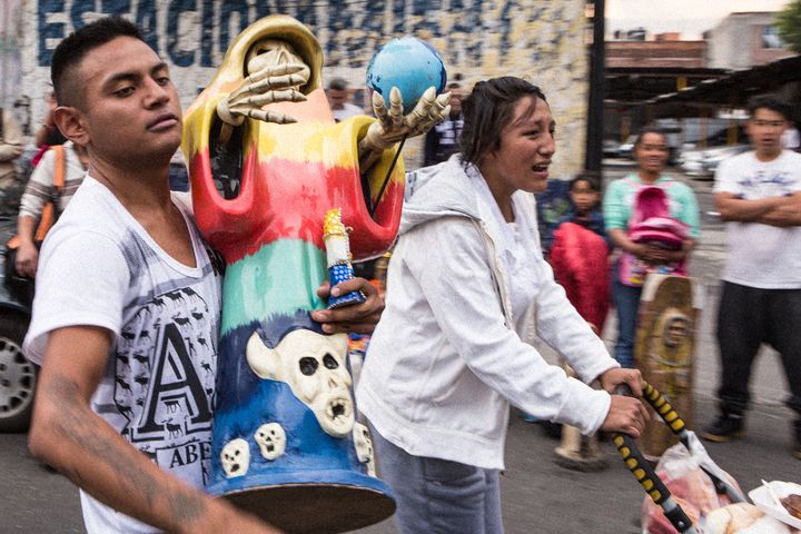 <p>A devotee who brought his Santa Muerte of the 7 Powers statue to be blessed at the Tepito shrine</p>