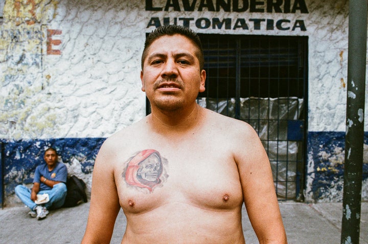 <p>A devotee with Santa Muerte tattooed on his chest at the shrine in Tepito</p>