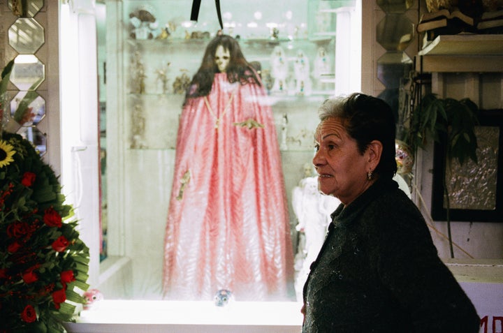 Santa Muerte Godmother Enriqueta Romero with the most famous effigy of the Bony Lady at her Tepito shrine