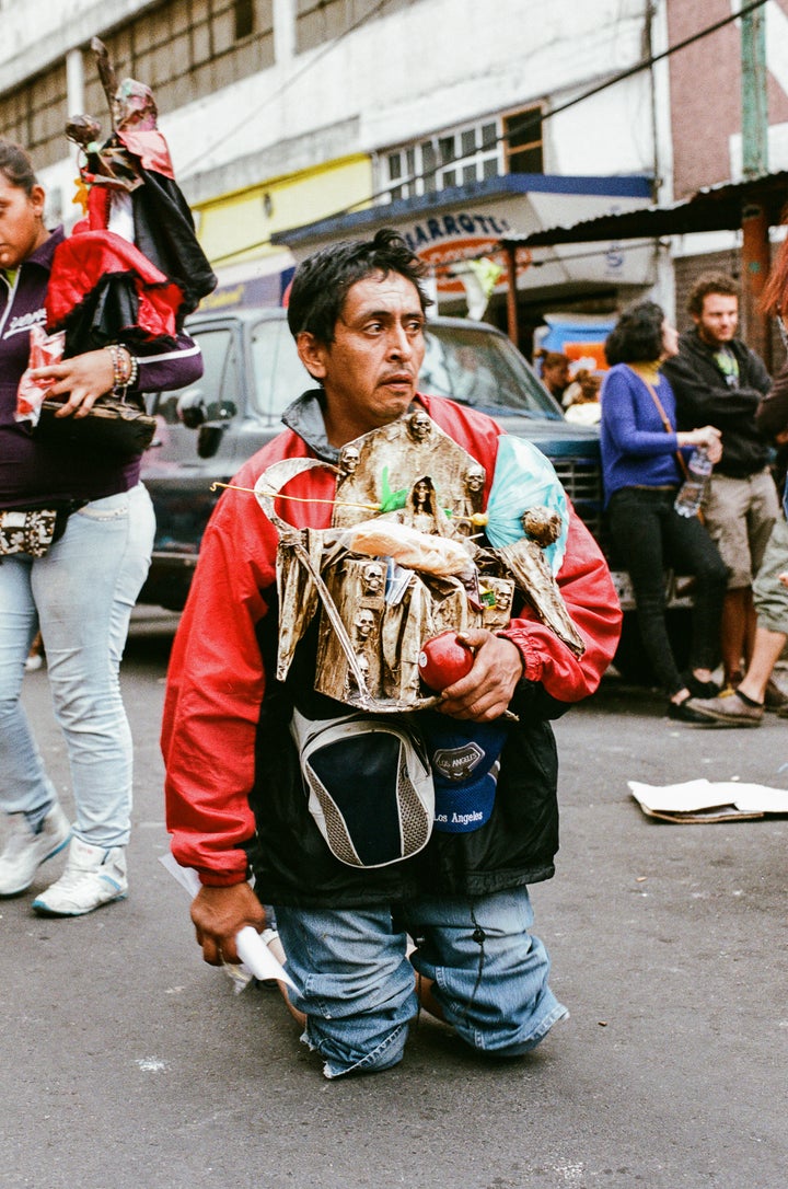 <p>A devotee making his way on his knees to the Santa Muerte shrine in Tepito</p>