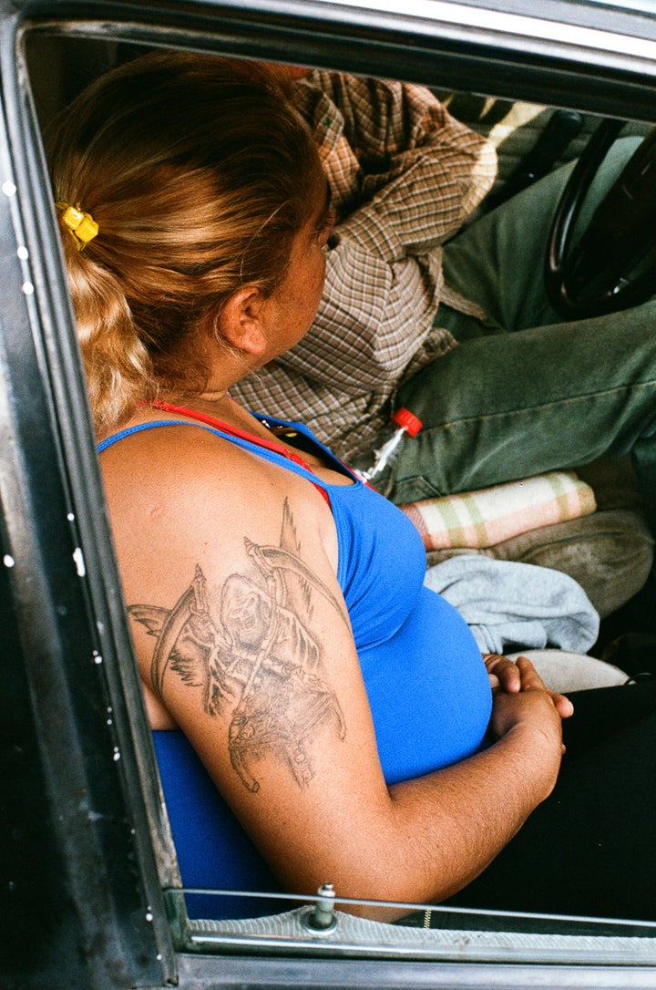 A devotee with the Bony Lady tattooed on her arm near the Santa Muerte shrine in Tepito