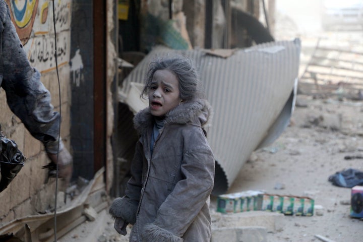 A Syrian child girl is seen at the scene of the air strikes carried out by the war crafts belonging to Russia and Assad regim