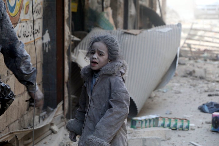 A Syrian child girl is seen at the scene of the air strikes carried out by the war crafts belonging to Russia and Assad regime forces in al-Shear neighbourhood of Aleppo, Syria on November 28, 2016.