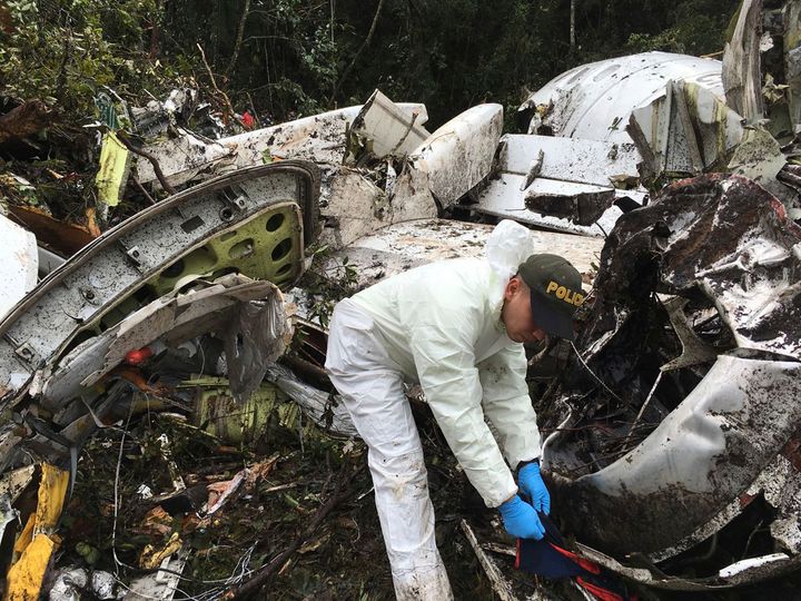 Police officers work on the wreckage of the Lamia plane.