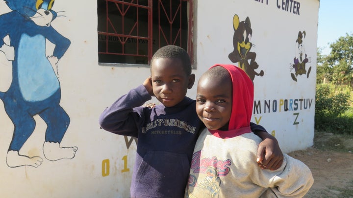 <p>Young boys in front of an ECD Center</p>