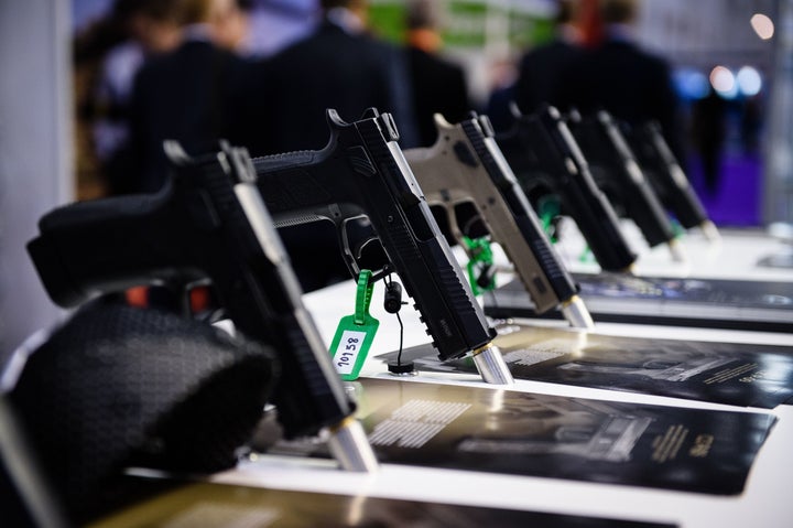 Pistols made by weapons manufacturer CZ sit on display inside the ExCeL centre in London on September 15, 2015, during the De
