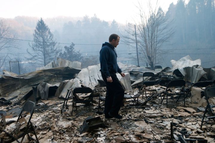 Trevor Cates walks through the smoldering remains of the Banner Missionary Baptist Church in Gatlinburg, Tennessee, after a wildfire on Nov. 29, 2016. 