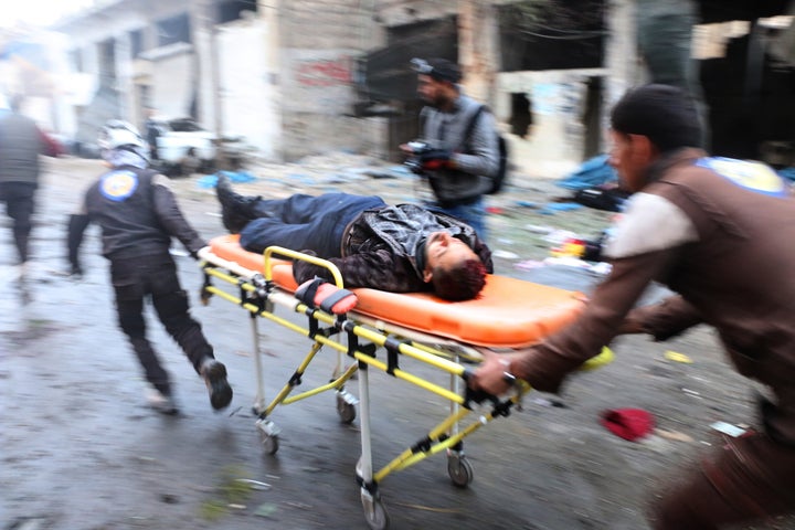 Search and rescue team members hospitalize a wounded civilian at the site of blast after Assad Regime's strike over civilians in residential areas of Jub Al Quba neighborhood of Aleppo, Syria on November 30, 2016.