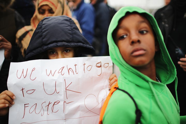 Children protest the slow process of heading to the UK, as they leave the Calais camp in October