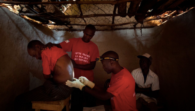 Doctors Without Borders staff perform a spinal tap to try to diagnose sleeping sickness, in the village of Basoloy, region of Doromo, northeastern Democratic Republic of Congo.