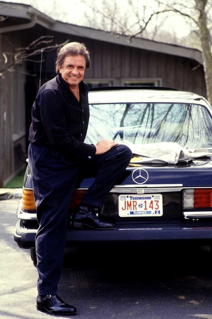 Johnny Cash shows off a car in the driveway, 1988.