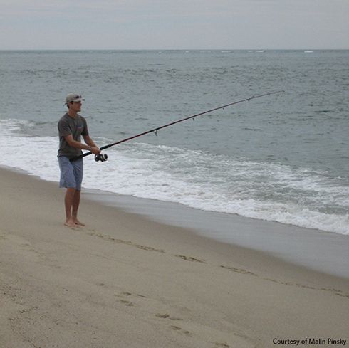 Malin Pinsky fishes for work, fun, and food. Here he surf casts near Cape Cod, Massachusetts, in 2010, in hopes of catching bluefish or striped bass for dinner. 
