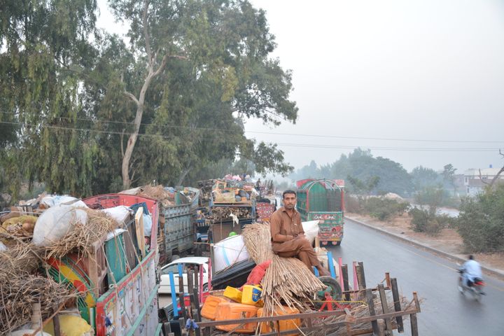 Marjan Khan, 33, rides atop a truck packed with all of his belongings on his way to Afghanistan. Khan was born in Pakistan and his family has lived in the country for 45 years.