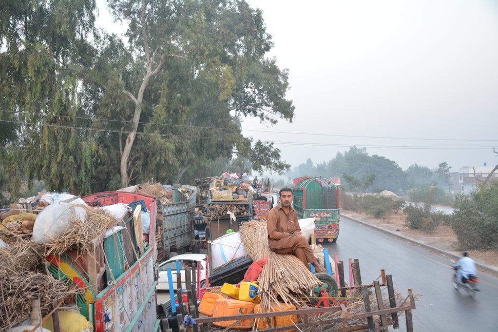 Marjan Khan, 33, rides atop a truck packed with all of his belongings on his way to Afghanistan. Khan was born in Pakistan an