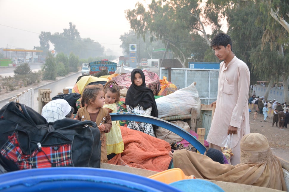 The family of Abdul Rahim sits with all of their belongings at the repatriation center in Peshawar, Pakistan. His family