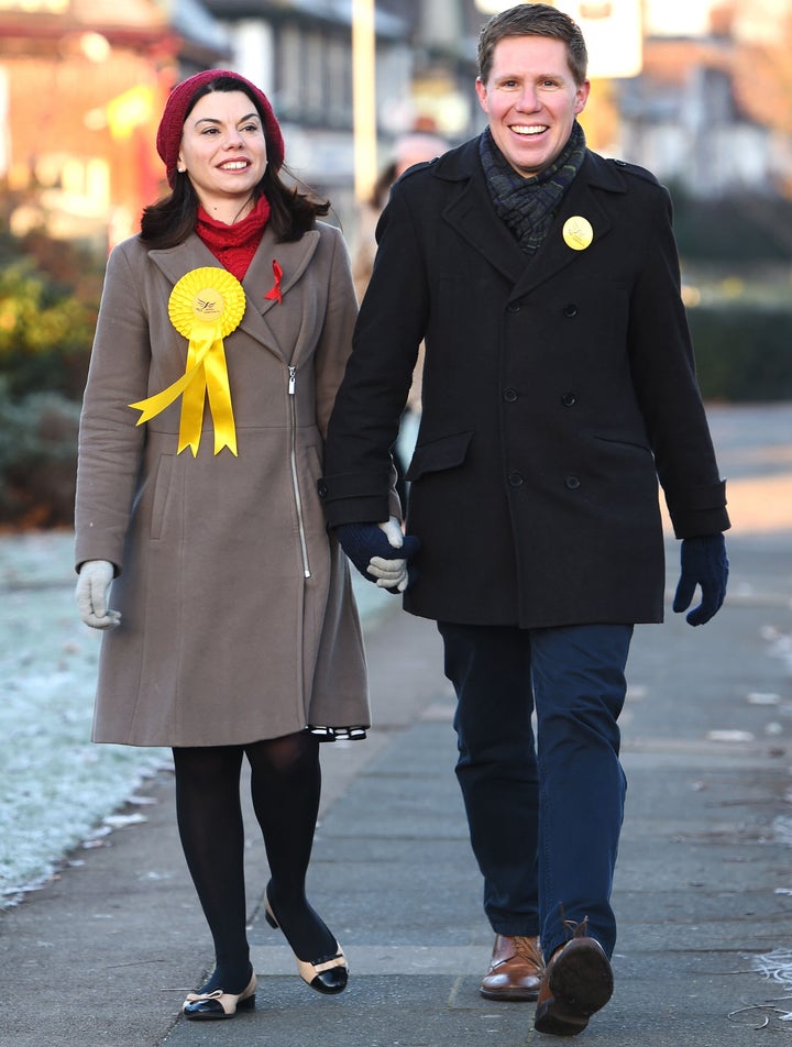 Liberal Democrat candidate Sarah Olney arrives with her husband Ben to vote at a polling station in Richmond today