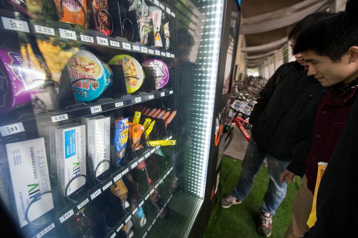 Students look at HIV testing kits in a vending machine in a university in Chengdu, Sichuan Province, China. 