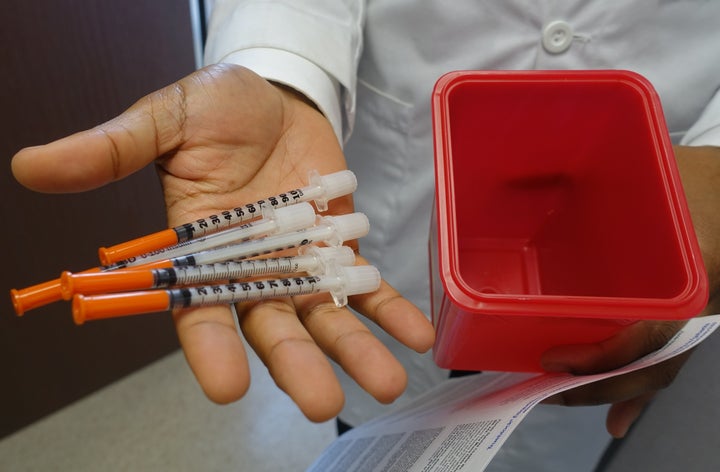 Hansel Tookes, a doctor at the University of Miami, holds needles on November 30, 2016, that will be given away to addicts at a new syringe exchange program, the first ever to open in a city where HIV rates are about double that of most major US cities.