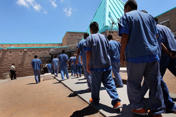 Detained immigrants walk back to their housing units following lunch at the U.S. Immigration and Customs Enforcement (ICE) detention facility on July 30, 2010 in Florence, Arizona. The Florence facility is run as a for-profit business by CoreCivic, the country's largest private prison contractor.
