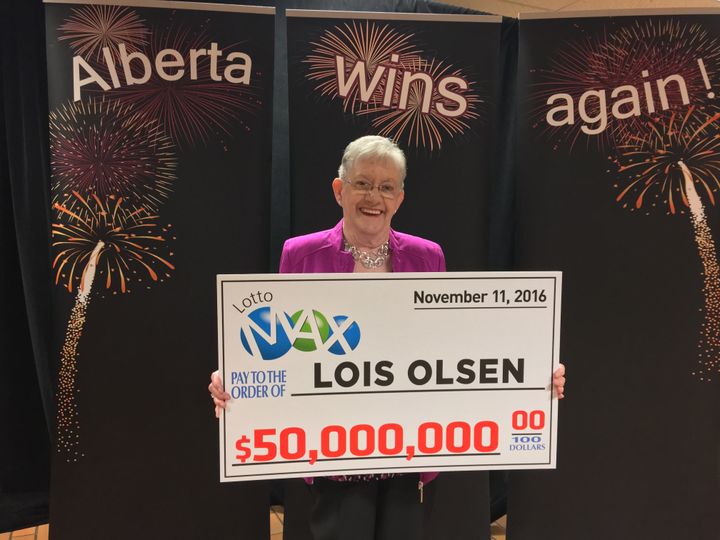 Lois Olsen collecting her gigantic check.