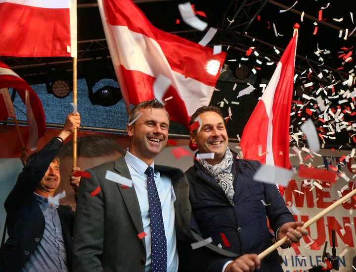 Norbert Hofer candidate for presidential elections of Austria's Freedom Party, FPOE, left, and Heinz-Christian Strache, right, head of Austria's Freedom Party, FPOE, look out at supporters in Vienna