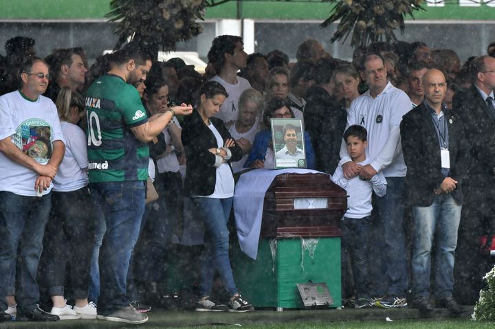 Relatives mourn over the coffin of Chapecoense football club staff member Sebastiao Burtet Filho 