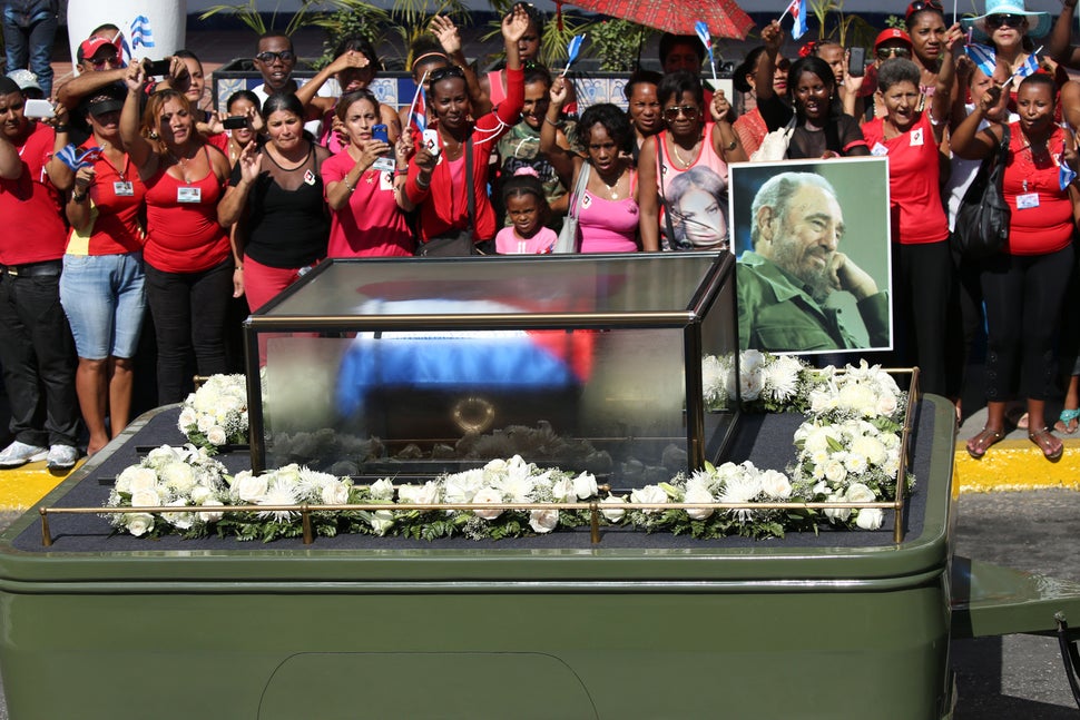 Residents wave as the caravan carrying the ashes of Cuba's late President Fidel Castro arrives in Santiago de Cuba, Cuba, Dec