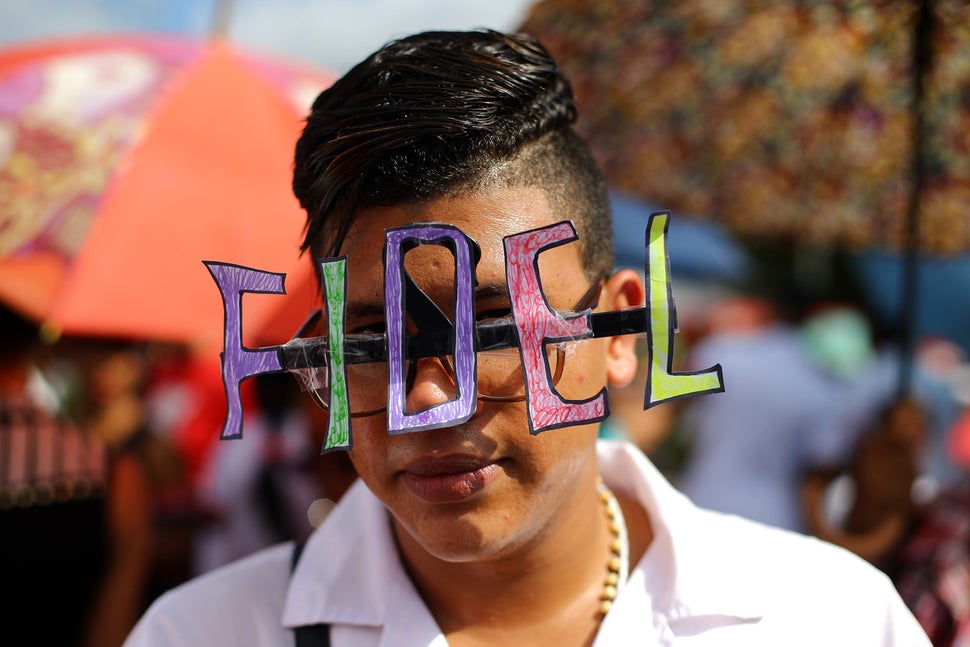 A student wears decorated eyeglasses as the caravan carrying the ashes of Cuba's late President Fidel Castro arrives in Santi