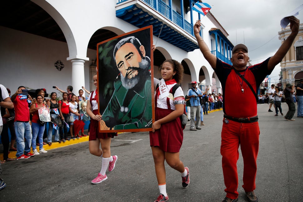 Students carry a portrait of Cuba's late President Fidel Castro as the caravan carrying Castro's ashes arrives in Santiago de
