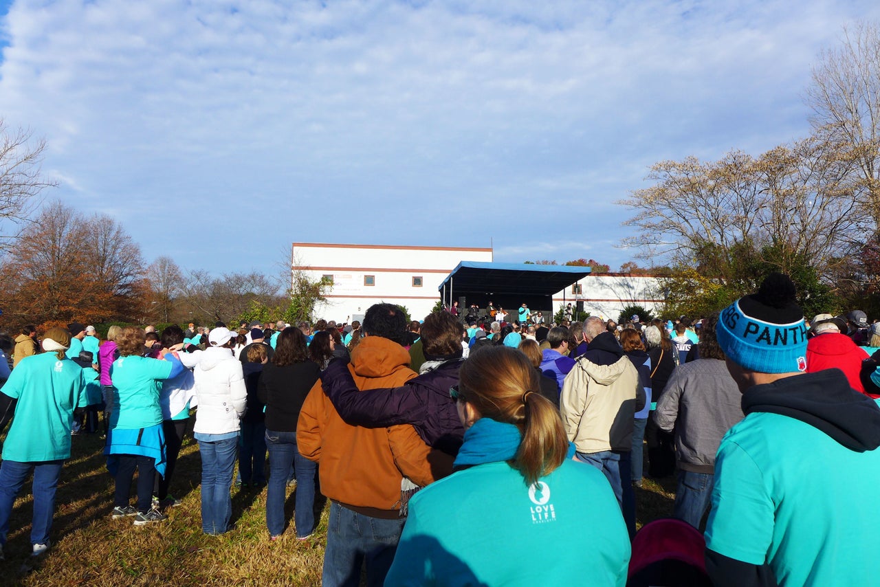 Love Life Charlotte members join in prayer before they begin to march.