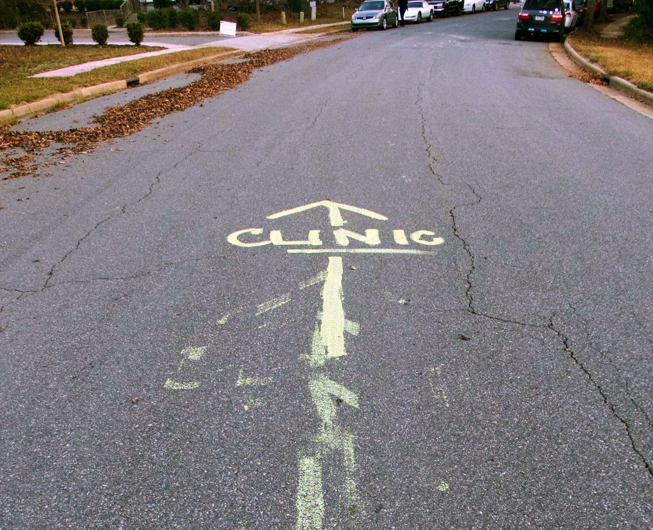 Directions to the clinic are painted on the street outside APWHC in Charlotte to avoid confusion with mobile crisis pregnancy centers stationed up the street from the clinic.