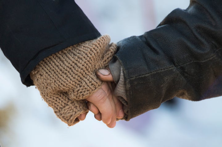 Activists hold hands during a prayer circle as they try to surround the entire camp at Oceti Sakowin Camp on the edge of the Standing Rock Sioux Reservation.