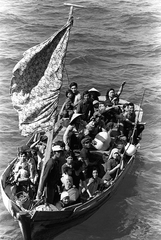 A boat with 35 Vietnamese refugees, waiting to be taken on board a U.S. naval vessel after spending eight days at sea.