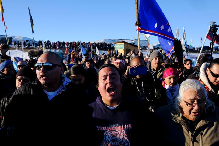 Dakota Access Pipeline protesters celebrate as they march back to the Oceti Sakowin campground after they found out the Army Corps of Engineers denied the easement to drill under Lake Oahe on Sunday, Dec. 4, 2016.