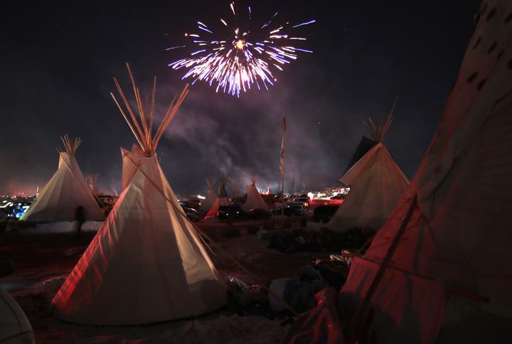 Fireworks fill the night sky above Oceti Sakowin Camp as activists celebrate after learning an easement had been denied for the Dakota Access Pipeline near the edge of the Standing Rock Sioux Reservation.
