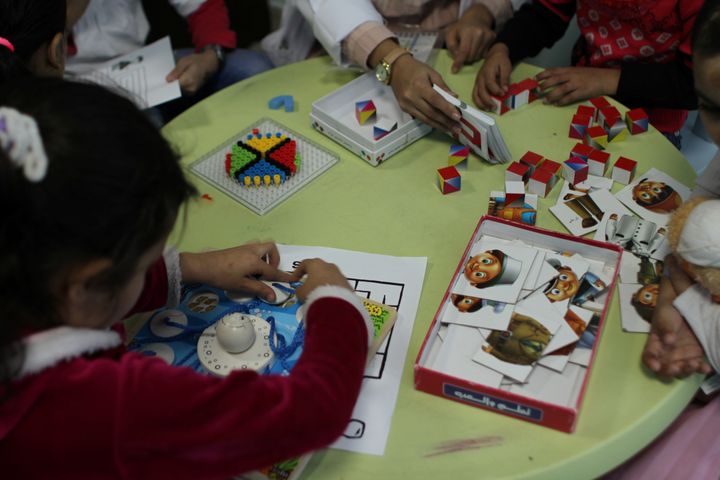 Young girls, severely burnt and maimed by explosions in Yemen, Syria and Iraq, play puzzles as an occupational therapist assesses their cognitive development inside a Medecins Sans Frontieres hospital in Amman, Jordan, November 20, 2016.
