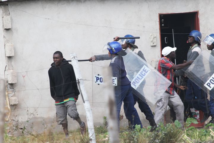 Zimbabwean police beat a protestor at a recent rally.