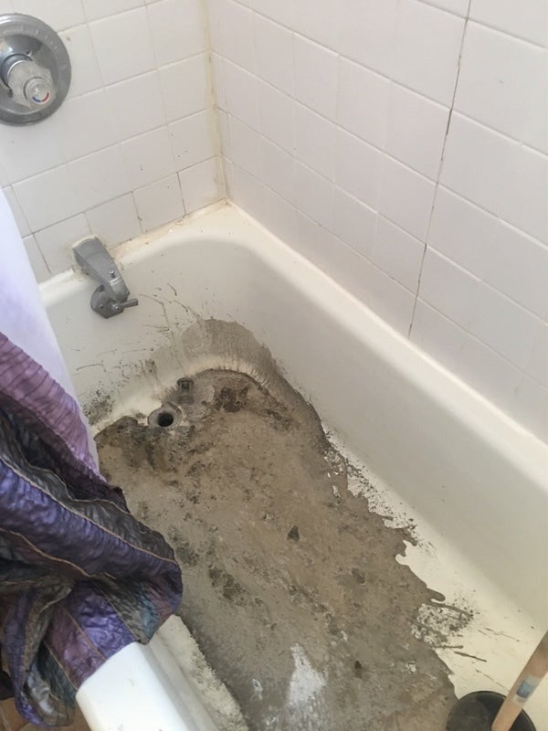 <p>Cement fills the drains of Pat and Joe Jude’s property. </p>