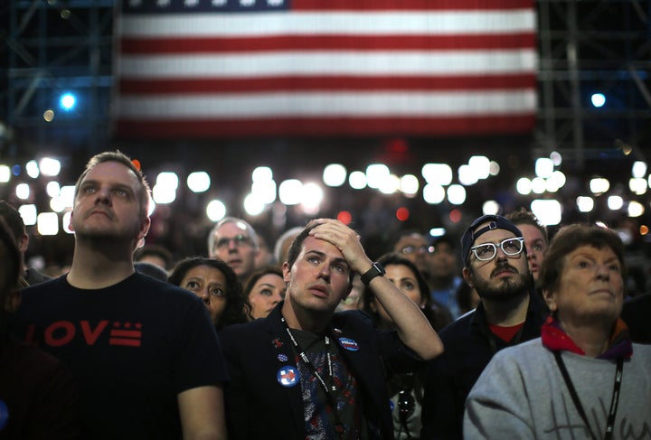 Supporters of Democratic presidential nominee Hillary Clinton watch and wait at her election night rally in New York, U.S., November 8, 2016.