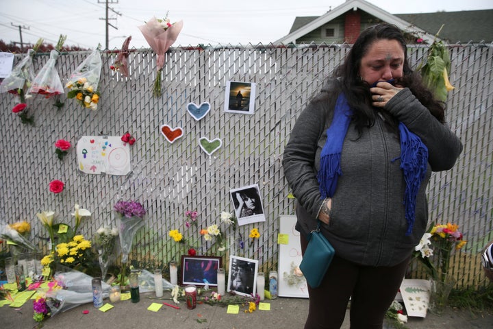 Danielle Boudreaux, 40, who went to the "Ghost Ship" warehouse many times, cries Monday at a sidewalk memorial near the burne
