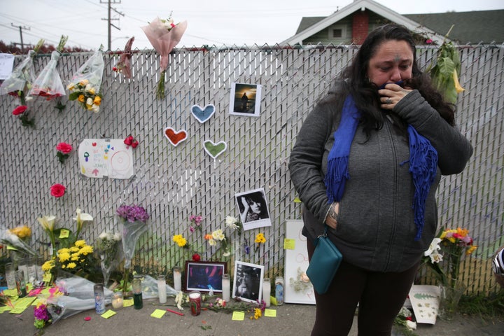 Danielle Boudreaux, 40, who went to the "Ghost Ship" warehouse many times, cries Monday at a sidewalk memorial near the burned warehouse following the fatal fire in the Fruitvale district of Oakland, California.