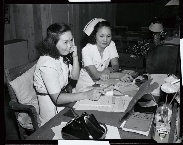 A newspaper photo shows two Japanese-American workers at an emergency medical unit in Honolulu, with the caption saying they are "typical of the loyal Japanese-Americans in the Islands; they have been on continuous duty since the attack on December 7."