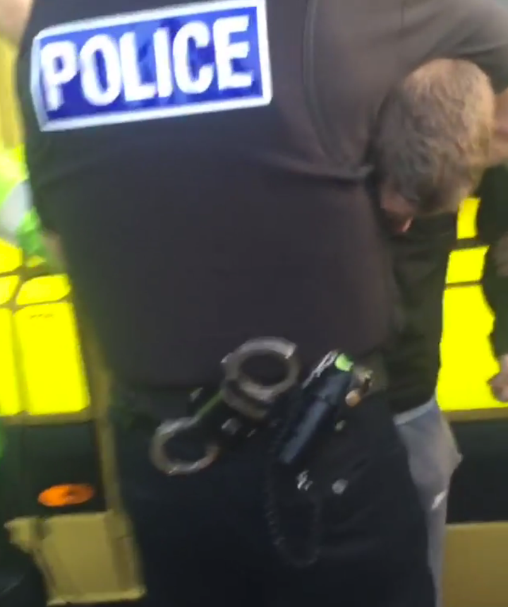 One of the teenagers is seen being restrained before he is arrested