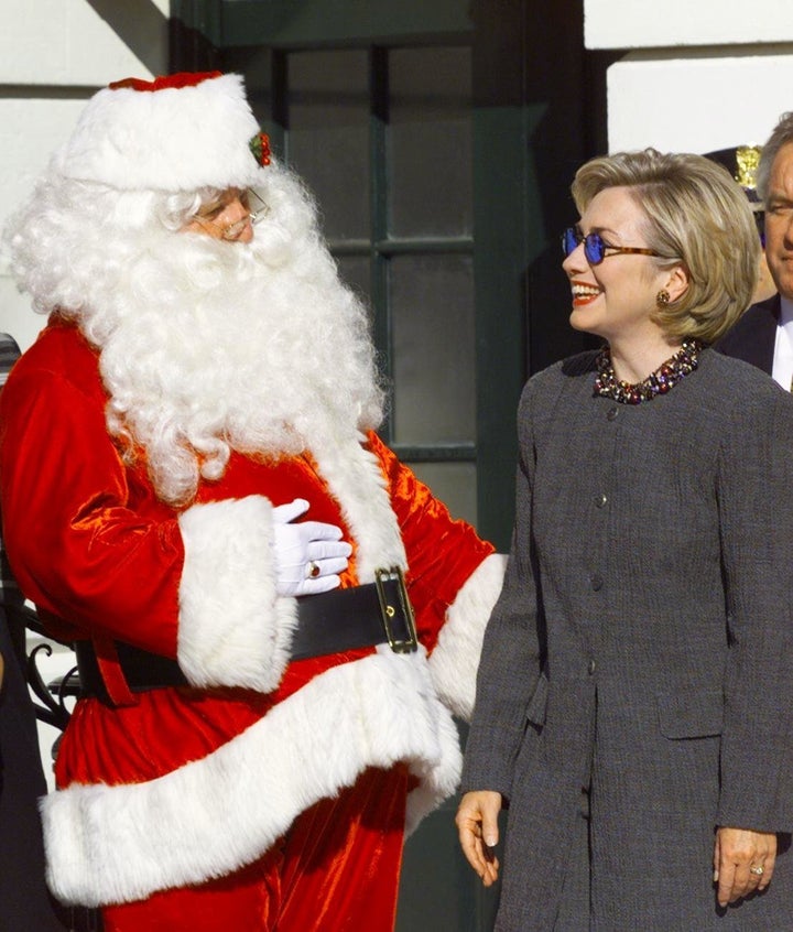 A santa was fired in Florida after telling a child that Hillary Clinton was on the 'naughty list'; Clinton is pictured above meeting Santa at the White House in 2001