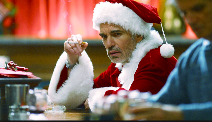 Billy Bob Thornton smokes while sitting at a bar in the movie Bad Santa; a Santa at a winter wonderland event in Cumbria was fired in November after being spotted smoking