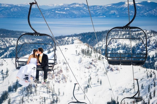 A ski lift offers a bird’s eye view of a stunning scenery, complete with mountain and lake.