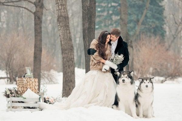 <p>What’s a winter wedding photo without a pair of <a href="http://bridalguide.com/planning/the-details/theme/pets-in-weddings#164790" target="_blank">fluffy, adorable huskies</a>? Their regal posture, a fresh covering of snow, and the bride’s layered ballgown and faux fur coat makes for an elegant vibe.</p>