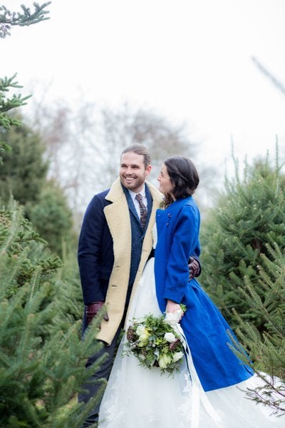 Surrounded by fresh evergreens and wrapped in peacoats, this couple is full of yuletide cheer.